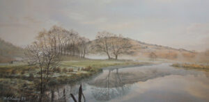 This is a signed limited edition print of an original soft pastel painting by artist Michael Howley. The subject of the painting is a calm wide view across Lake Elterwater as the mists of dawn clear. The sky is a pastel shade of blue with soft white and pink clouds. The distant peach coloured hills are reflected in the still waters along with bare trees of early spring. To the left is the soft green foreground banking with 2 small figures walking into the mist. A dark shape of broken fencing adds focus to the foreground.