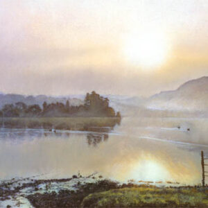 This is a signed limited edition print from an original soft pastel painting by artist Michael Howley. A misty sunrise pervades this panoramic lakeland scene with the warm glow of sunrise reflected in the lake. The sky goes from pastel blues and pinky purples to soft red-oranges, all of which are reflected in the water. Distant hills are blue-grey and the islands and land masses form a dark silhouetted contrast.