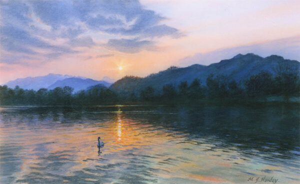 This is a signed limited edition print from an original soft pastel painting by artist Michael Howley. In this lakeland scene, a swan floats serenely by a reflection of the setting sun. The soft blue clouds, rosey glow of the setting sun and the blue-grey hues of the darkening hills are reflected in the lake with deepening tones in the foreground.